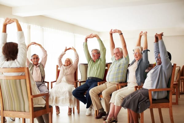 Residents participating in an exercise class in the common area