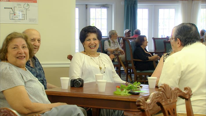 Residents chatting in a common area of the facility