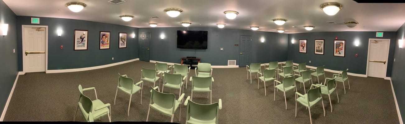 Interior view of a common area with chairs and a TV