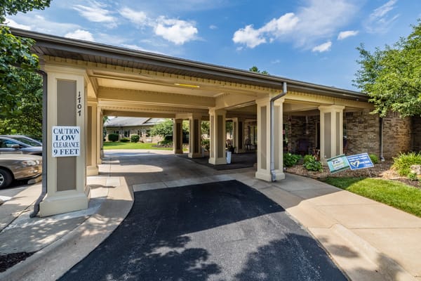 Entrance driveway of The Manor at Elfindale with low clearance sign.
