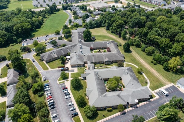 Aerial view of The Manor at Elfindale senior living facility surrounded by greenery.
