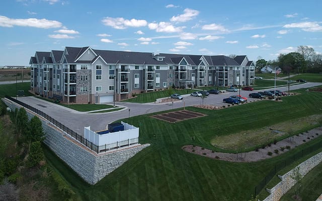 Aerial view of a senior living facility with landscaped grounds