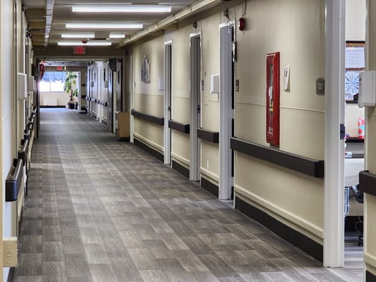 Well-lit hallway in a senior living facility