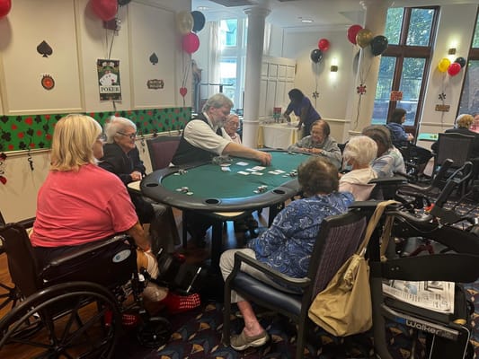 Residents engaging in a poker game in a common area