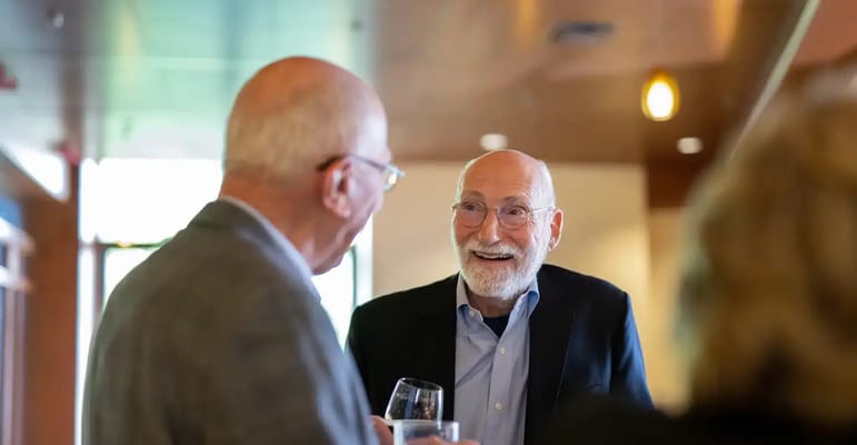 Two residents engaged in conversation at a gathering
