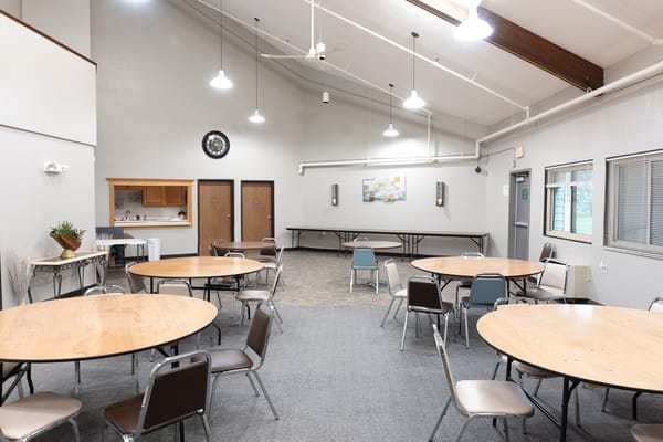 Bright common area with tables and chairs arranged