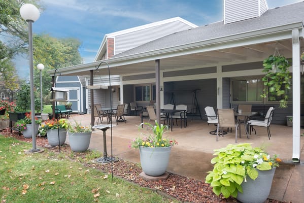 Outdoor patio area with seating and flowers