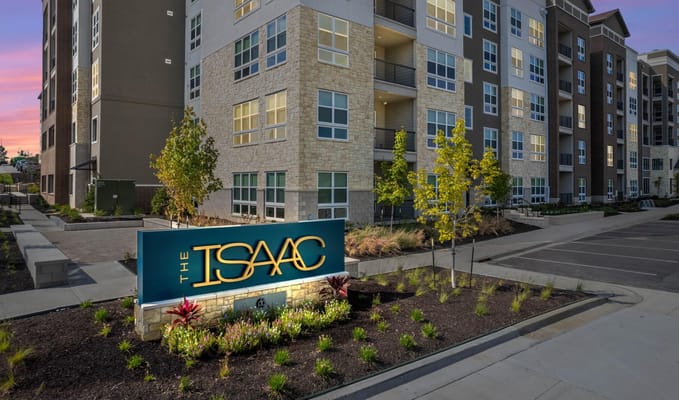Exterior view of The Isaac Active Adult Apartments sign