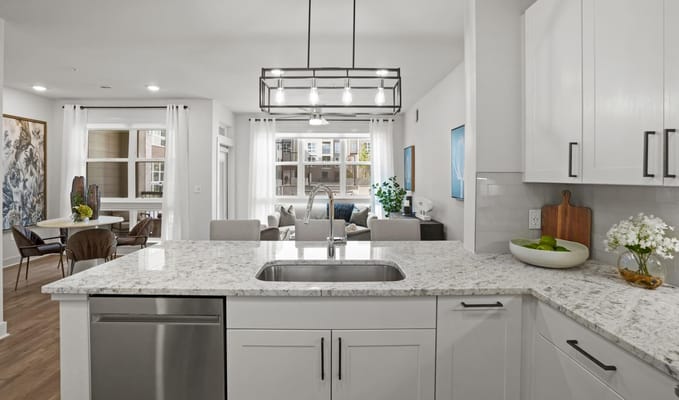 Modern kitchen view with living area in the background