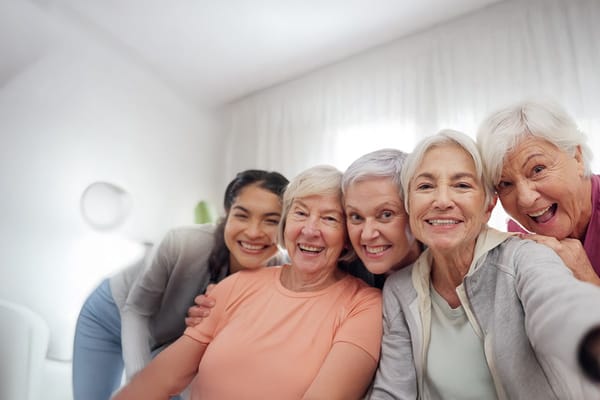 Residents smiling together in a bright common area