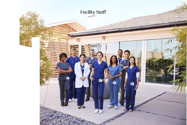Outdoor photo of facility staff in scrubs
