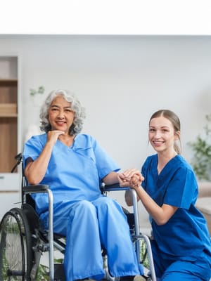 Caregiver assisting a resident in a bright interior space