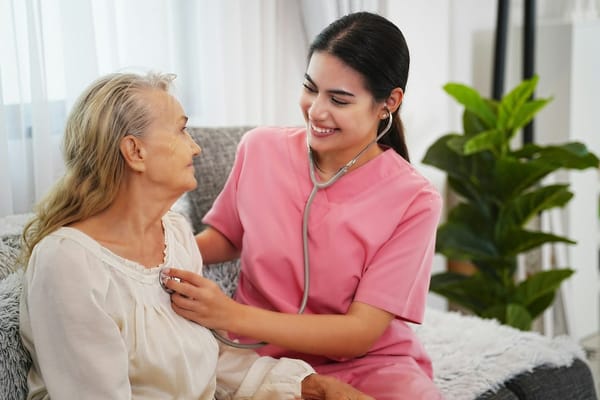 Nurse interacting with a senior resident indoors