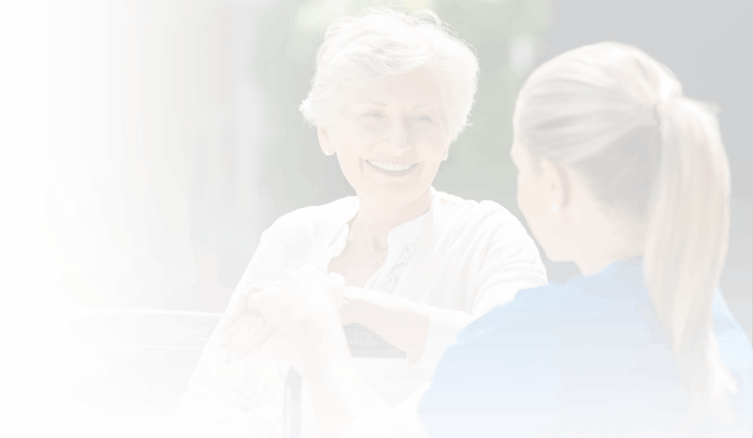 Resident and staff member engaging in conversation outdoors