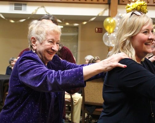 Residents enjoying a celebration inside the facility