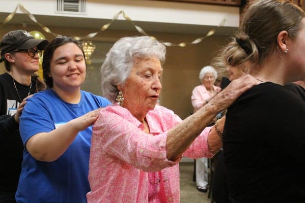 Residents participating in an engaging activity with staff