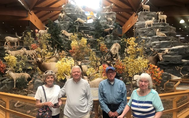 Residents posing in a common area with a decorative backdrop