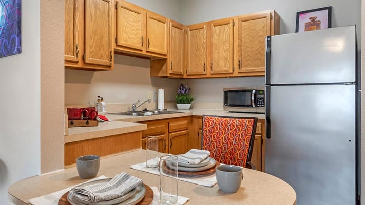 A well-lit kitchen area with a dining table