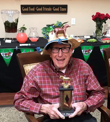 Resident celebrating with a trophy during an activity