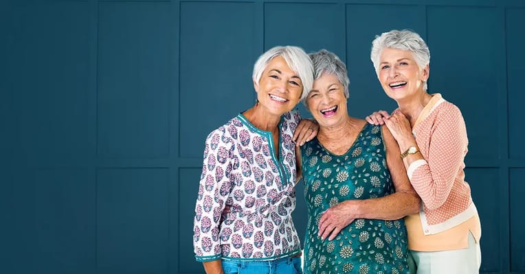 Three smiling seniors posing together