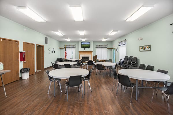 Interior view of a spacious common area with tables and chairs