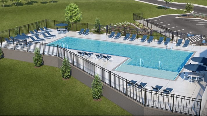 Outdoor pool area with lounge chairs and fencing