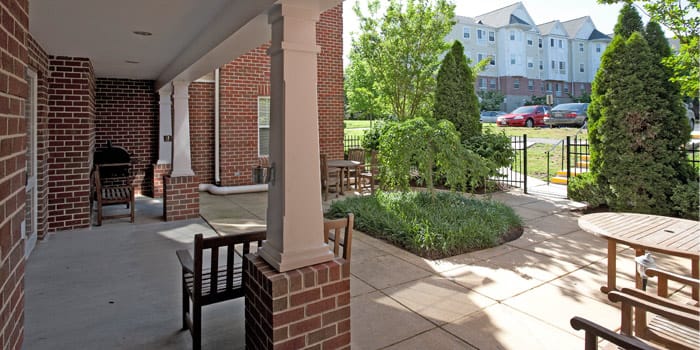 Outdoor seating area with greenery in a senior community