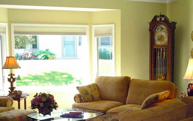 Cozy common area with a couch and large windows