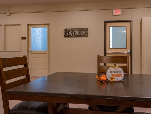 Cozy common area with a welcome sign and chairs