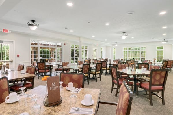 Spacious dining area with tables, chairs, and natural light