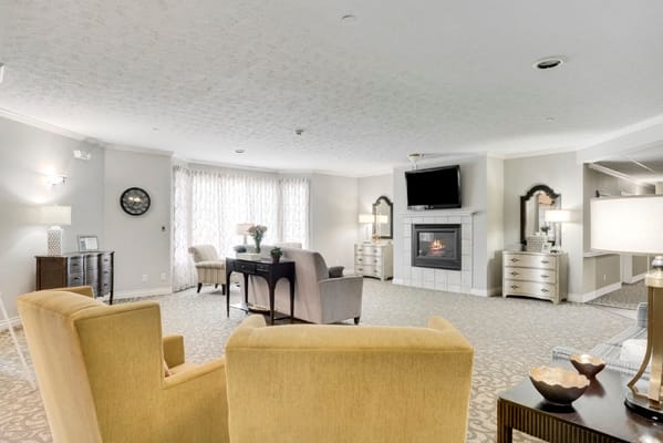 Inviting living room with a fireplace, comfortable seating, and large windows