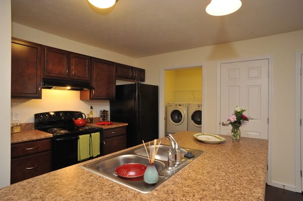 Spacious kitchen with modern appliances and laundry area