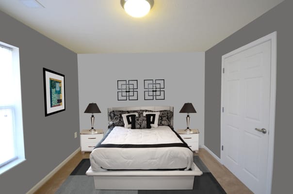 A cozy bedroom featuring a double bed, lamps, and artwork.