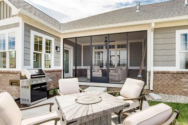 Outdoor patio area with seating and grill