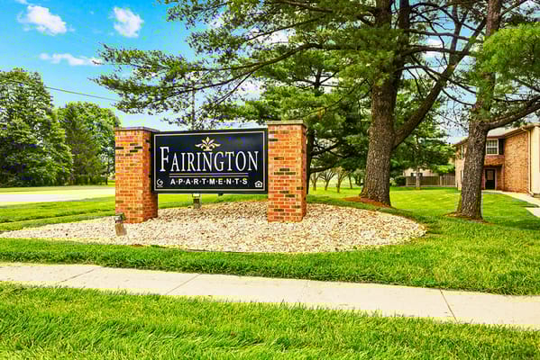 Sign for Fairington Apartments outside on green grass