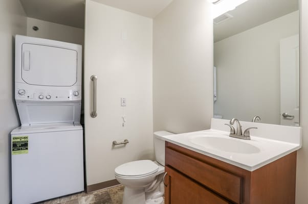Laundry machines in a compact bathroom setting