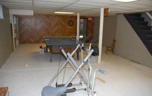 Recreation room with exercise equipment and a ping pong table