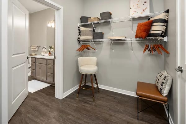 Interior view of a well-organized closet area adjacent to a bathroom.