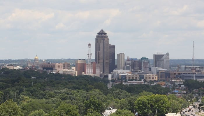 Panoramic view of downtown Des Moines with green trees in the foreground
