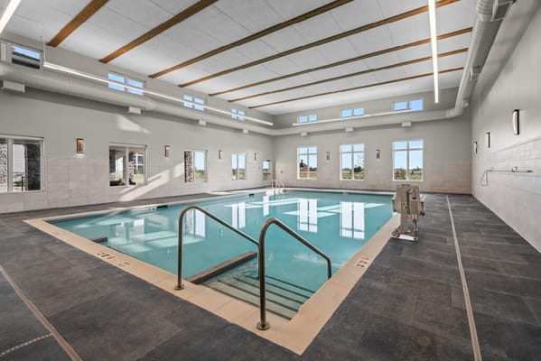 Indoor swimming pool with natural light and large windows