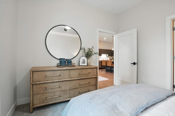Cozy bedroom with dresser and mirror