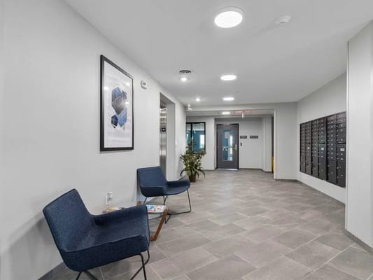 Bright lobby area with seating and mailboxes