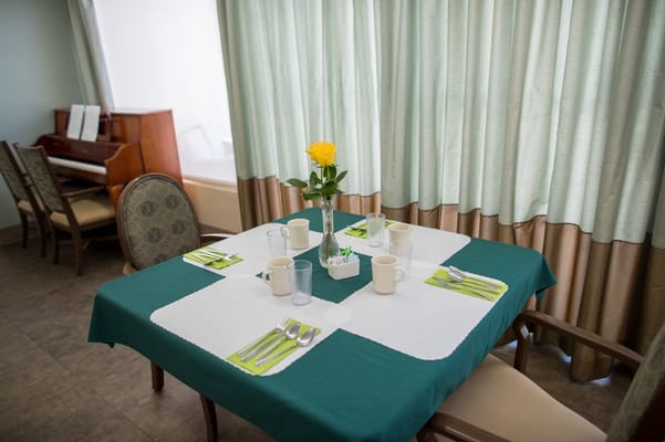 Dining area set with cutlery and flower vase