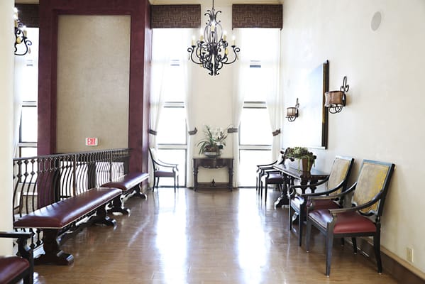 Lobby seating area with decorative lighting and floral arrangement