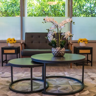 A cozy common area with seating and floral decor