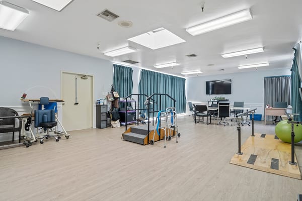 A spacious therapy room with equipment and seating