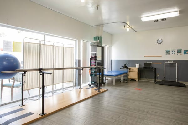 Physical therapy room with equipment and natural light