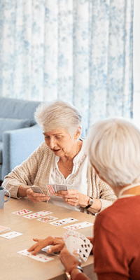 Residents playing cards in a social activity