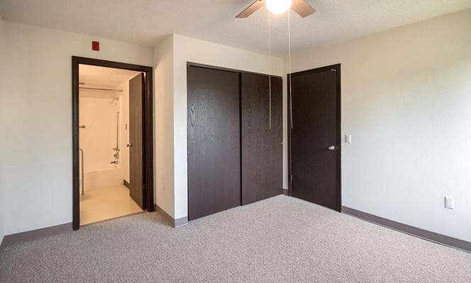Empty interior room with closet space and a ceiling fan