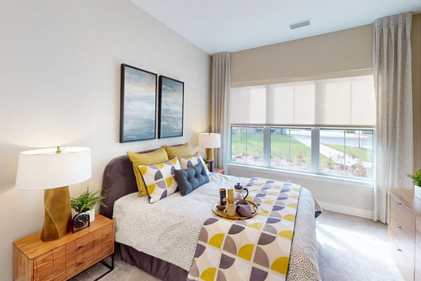 Cozy private room with a decorative bed and natural light